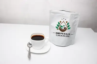 a bag and a cup of coffee on a table at Hospedaje EL EDEN DE DON AYDEN in Satipo