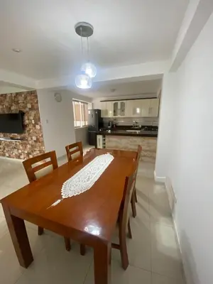 a kitchen and dining room with a wooden table and chairs at Beautiful Complete Apartment in Lima