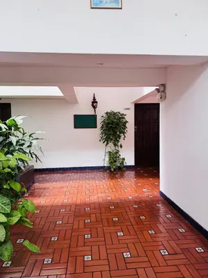a room with a brick floor and a black door at Monterrico Polo Aparts 6 - DPTO CON 3 CAMAS FRENTE EMBAJADA USA in Lima