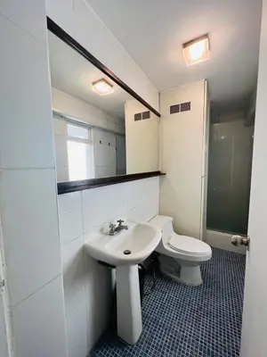 a bathroom with a sink and a toilet and a mirror at Monterrico Polo Aparts 6 - DPTO CON 3 CAMAS FRENTE EMBAJADA USA in Lima