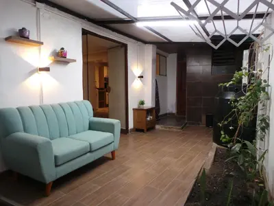 a living room with a blue couch in a room at Apartamento Céntrico in Cusco