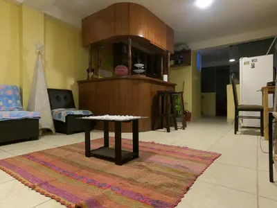 a living room with a table on a rug at Mirador Ernesto Gunter in Cusco