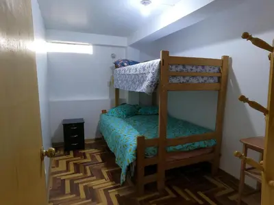 a small room with a bunk bed and a ladder at Mirador Ernesto Gunter in Cusco