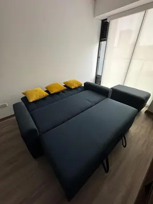 a couch with two yellow pillows in a room at Premium apartment in Miraflores with rooftop pool in Lima