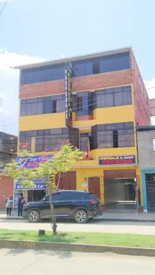 a blue van parked in front of a building at Hospedaje El Sureño in Satipo