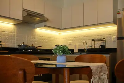 a kitchen with a table with a vase of flowers on it at Brand new apartment in Olivar of San Felipe in Lima