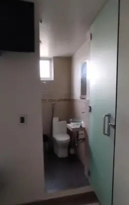 a small bathroom with a toilet and a window at Alojate en Mala casa del valle in Mala