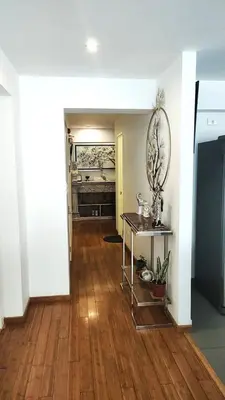 a living room with a wooden floor and a table at Apartment modern full 3BR near Larcomar, Miraflores, Lima, Peru Sunset all days in Lima