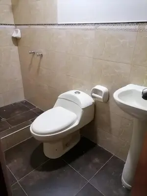 a bathroom with a toilet and a sink at Departamento cómodo para una estancia feliz in Ayacucho