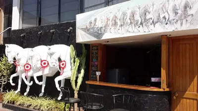 a building with a sign with bulls on it at Belle Sand Hotel in Ica