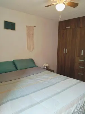 a bedroom with a bed and a ceiling fan at Adriana in Lima