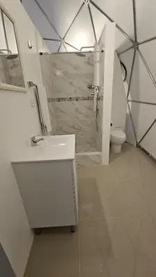 a bathroom with a shower and a sink and a toilet at Sky domos - laguna huaypo in Anta