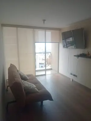 a living room with a couch and a large window at Alto Alborada Cercado in Lima