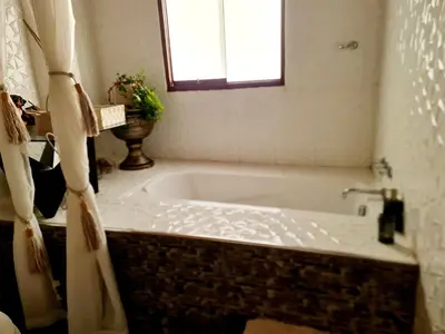 a bath tub in a bathroom with a window at Arins House in Cusco