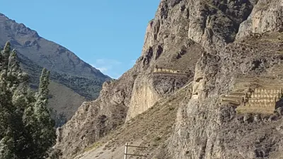 a mountain with a train on the side of it at Tambo de Ollantay Hotel in Ollantaytambo