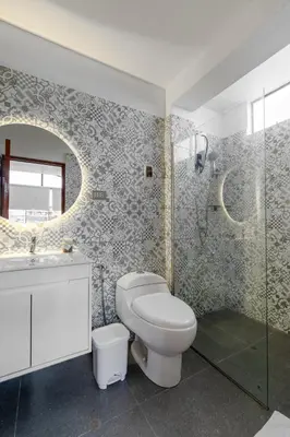 a bathroom with a toilet and a sink and a shower at Huaral House in Huaral