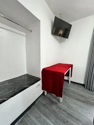 a room with a red table and a red bench at Habitaciones para Turistas en Zona Tranquila de Cusco in Cusco