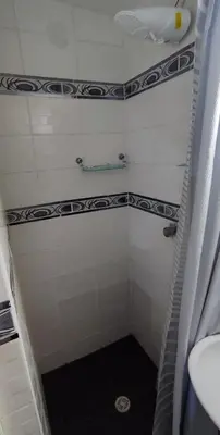 a small bathroom with a shower and a sink at Monoambiente a 20 minutos del Aeropuerto, moderno y privado in Lima
