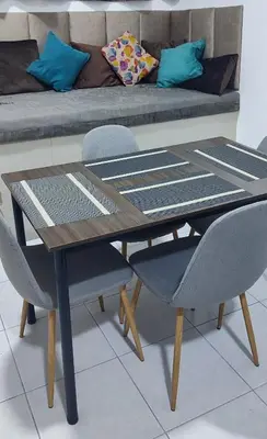 a table and two chairs with a couch in the background at Monoambiente Parque Naranjal B, a 20 minutos del Aeropuerto - Hasta 3 huéspedes in Lima