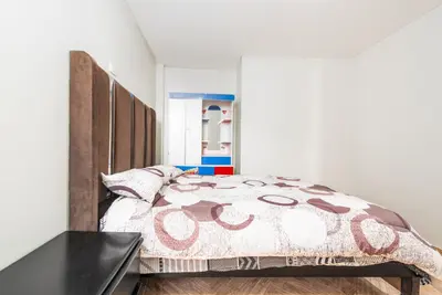 a bedroom with a large bed with a wooden headboard at Alameda Suite Ayacucho in Ayacucho