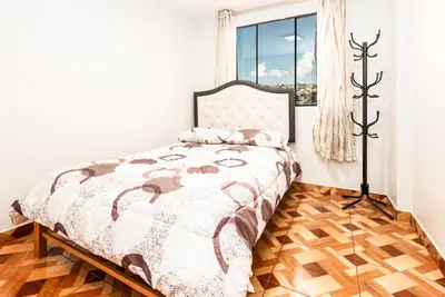a bedroom with a bed and a window at Alameda Suite Ayacucho in Ayacucho