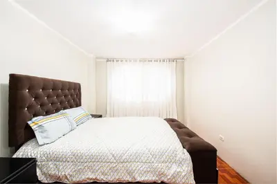 a bedroom with a large bed and a window at Alameda Suite Ayacucho in Ayacucho
