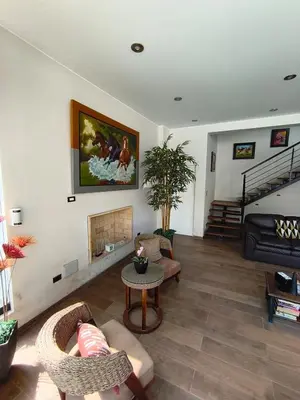 a living room with a couch and a fireplace at La Morada del Sol in Cieneguilla
