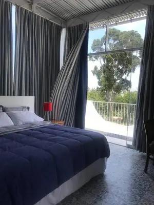 a bedroom with a bed and a large window at Miraflores Penthouse in Lima