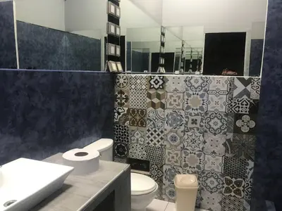 a bathroom with a toilet and a sink and a mirror at Miraflores Penthouse in Lima