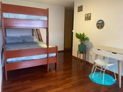 a bedroom with a bunk bed with a desk and a desk at Departamento en Santiago de Surco in Lima