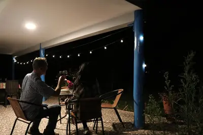 a man and woman sitting at a table under a tent at Country house in nature in Sacred Valley in Huayllabamba