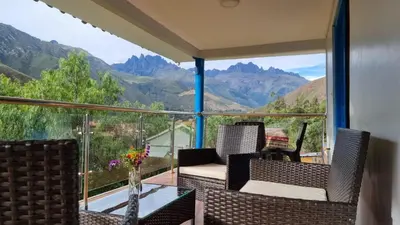a balcony with chairs and a view of mountains at Country house in nature in Sacred Valley in Huayllabamba
