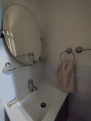 a bathroom with a sink with a large mirror at Panoramic view apartment in Lima