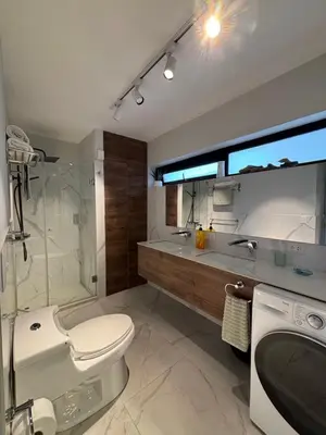 a bathroom with a toilet and a shower and a sink at Mar Private Rooms in Lima