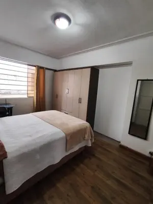 a bedroom with a large white bed and wooden floors at Miraflores apartment near Larcomar in Lima