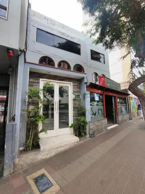 a white building with a door on a street at Miraflores apartment near Larcomar in Lima