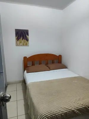 a bedroom with two beds and a painting on the wall at Miraflores apartment near Larcomar in Lima