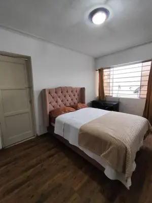 a bedroom with a large bed and a window at Miraflores apartment near Larcomar in Lima