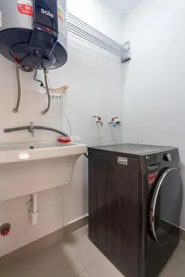 a bathroom with a sink and a washing machine at Elmora 2BR by Geko in Lima