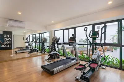 a gym with treadmills and elliptical machines at Elmora 2BR by Geko in Lima