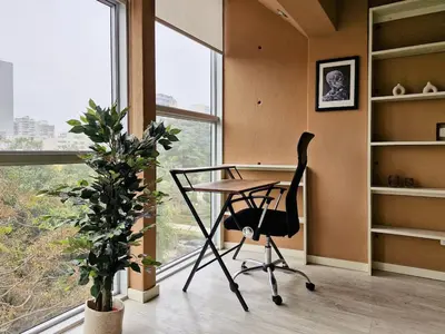 a desk and a chair in a room with a window at Spacio 299 by Geko in Lima
