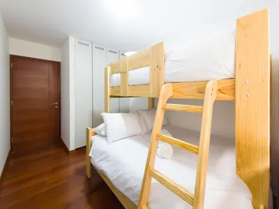 a bunk bed in a room with a ladder at Meridian 3BR by Geko in Lima