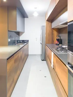 a kitchen with wooden cabinets and stainless steel appliances at Meridian 3BR by Geko in Lima