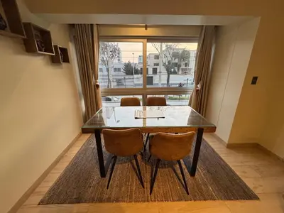 a dining room table with two chairs and a window at Miraflores 1 Bedroom Executive Apartment in Lima