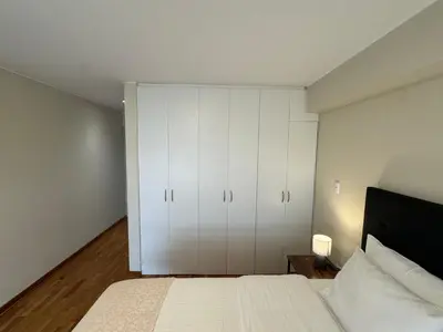 a bedroom with a bed and white cabinets at Miraflores 1 Bedroom Executive Apartment in Lima