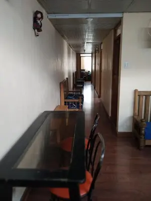a dining room with a glass table and chairs at TantaWasi in Cusco
