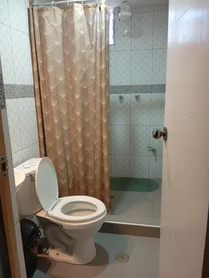 a bathroom with a toilet and a shower at TantaWasi in Cusco