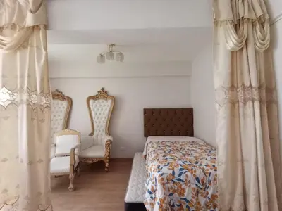 a bedroom with a bed and two chairs at Versalles Apartment in Lima