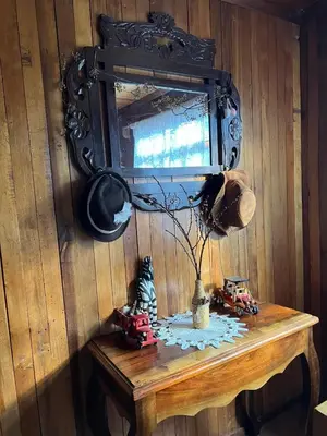 a mirror on a wall above a table with toy cars at Schütze-Haus in Oxapampa