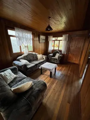 a living room with a couch and a table at Schütze-Haus in Oxapampa